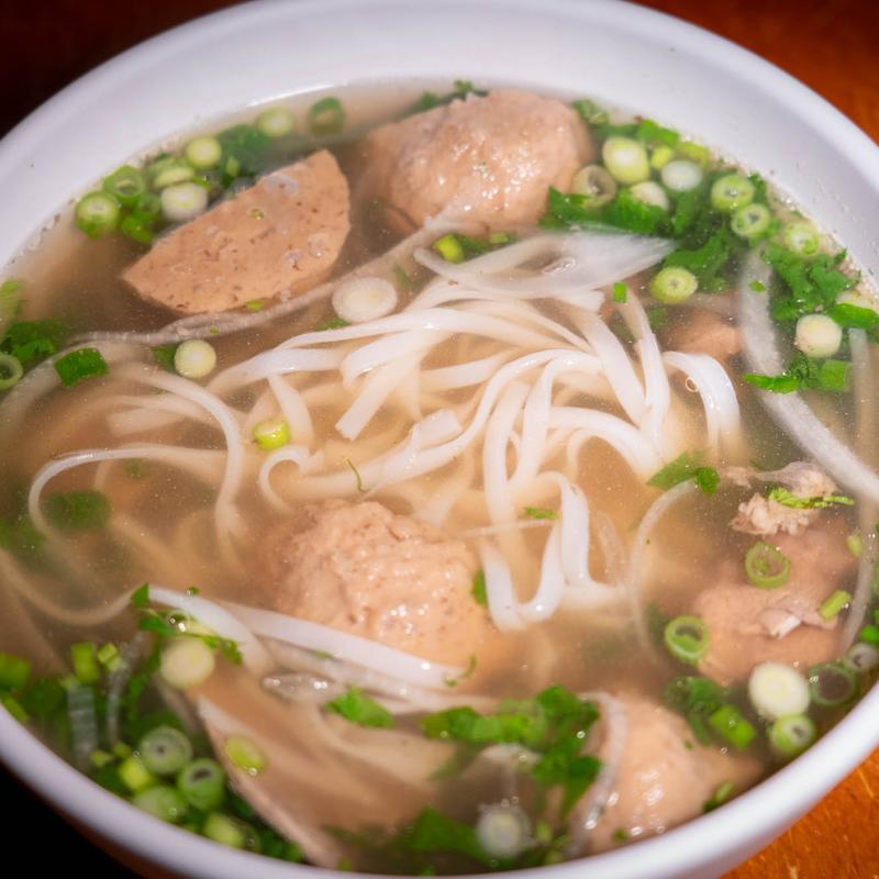 Bowl of beef meatball pho with rice noodles, scallions, and broth