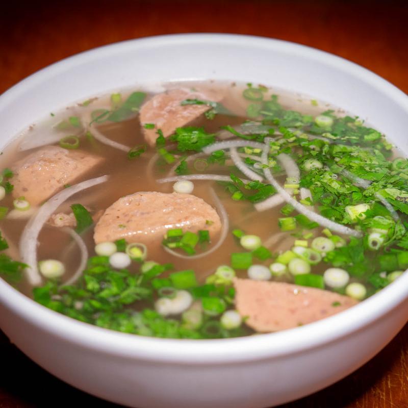 Bowl of Vietnamese pork meatball pho with onions and scallions